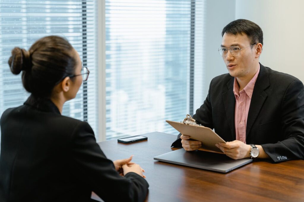 Asian man being in a job interview with a female professional